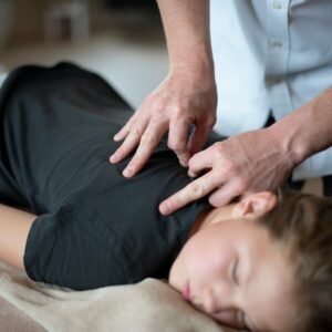 a woman getting a back massage from a massager