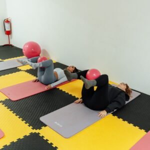 a group of people doing yoga in a room