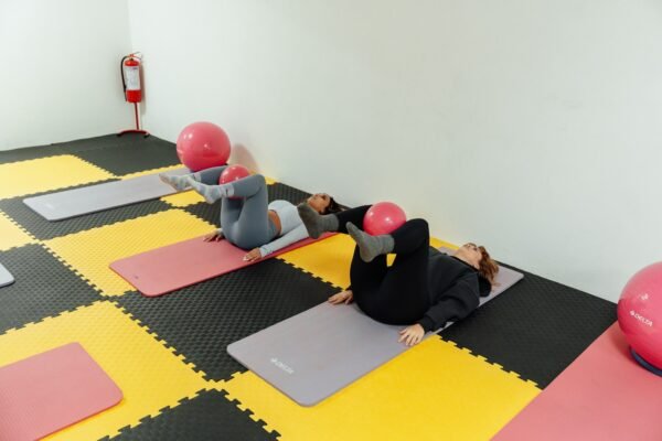 a group of people doing yoga in a room